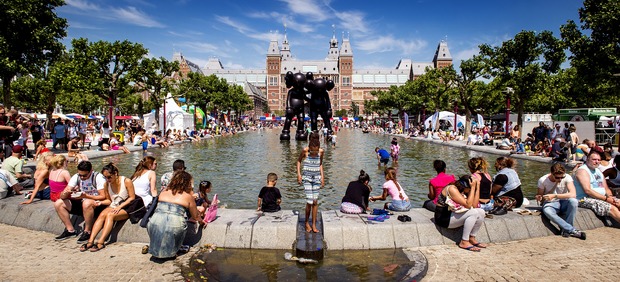 People cool off at a fountain in Amsterdam
