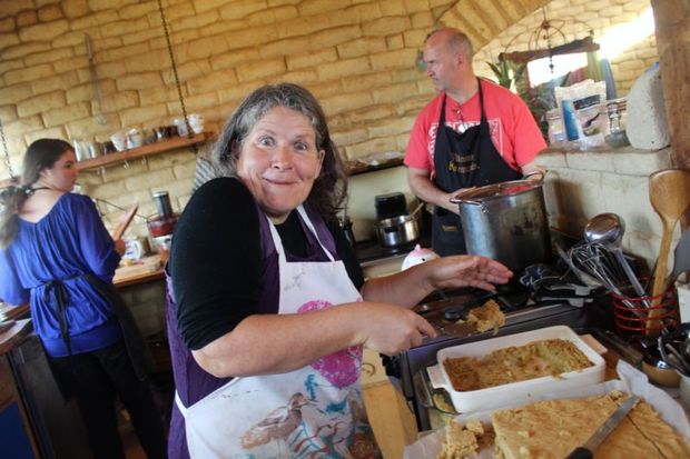 This is an image of Daring Donna the cook in the kitchen. Donna's partner, furniture maker  Darren Hunter is in the background , and youth crew member Jade. 