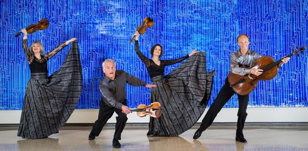 New Zealand String Quartet dance against a John Reynolds art work 