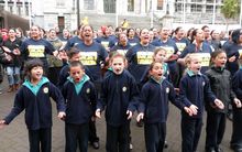 Former students join the Hastings community in a haka outside Parliament.