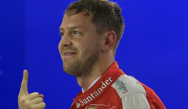 Ferrari's Sebastian Vettel celebrates winning.