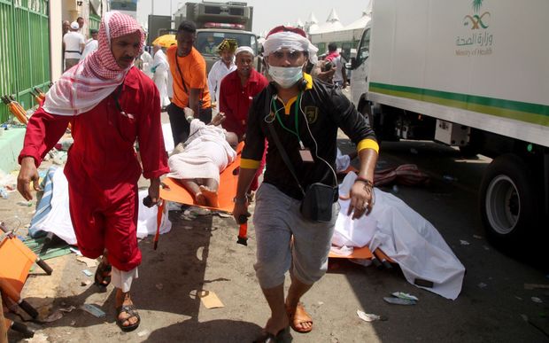 Saudi emergency personnel and Hajj pilgrims carry a wounded person at the site where hundreds were killed in a stampede in Mina, near the holy city of Mecca. 