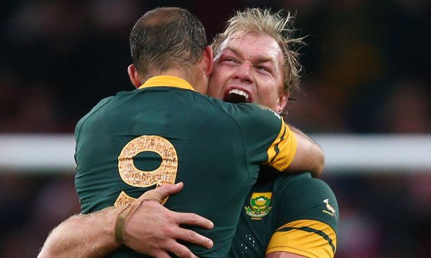 Schalk Burger of South Africa hugs Fourie Du Preez (no.9) as they celebrate their quarter-final win over Wales.