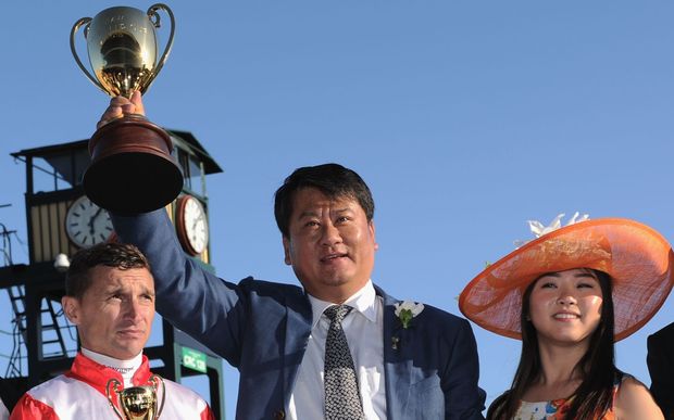  Winning owner Lin Lang poses with trophy with jockey Opie Bosson.