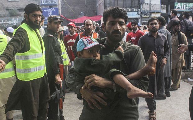 An injured boy is carried to hospital in Peshawar, Pakistan.