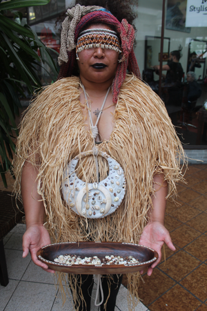 An image of artist Reina Sutton wearing traditional shell adornment from the Solomon Islands.