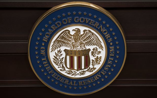 The US Federal Reserve seal. AFP PHOTO/BRENDAN SMIALOWSKI