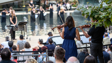 An orchestra plays on the waterfront.