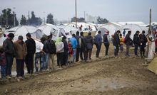 Refugees wait in queues to get food at the Idomeni refugee camp in Greece.