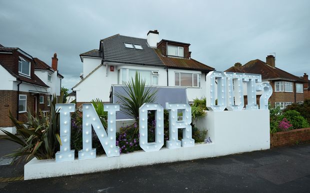 An illuminated "In or Out" sign outside a house in Hangleton, near Brighton in southern England, as Britain holds a referendum on EU membership.
