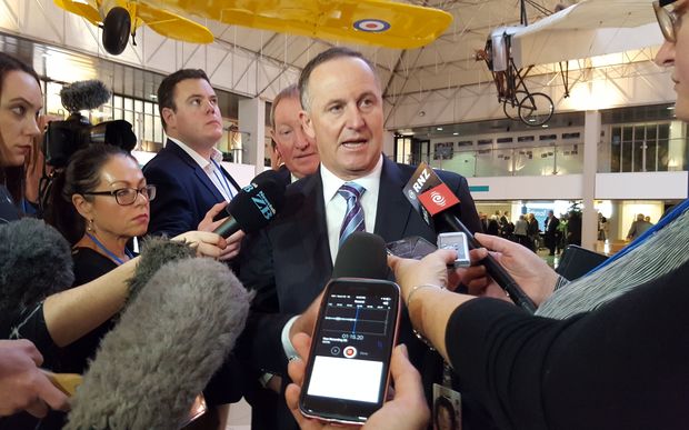 Prime Minister John Key speaks to media outside the National Party conference in Christchurch.