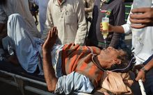 Hospital volunteers bring in an injured man who was shot during clashes between security forces and protesters in Srinagar.