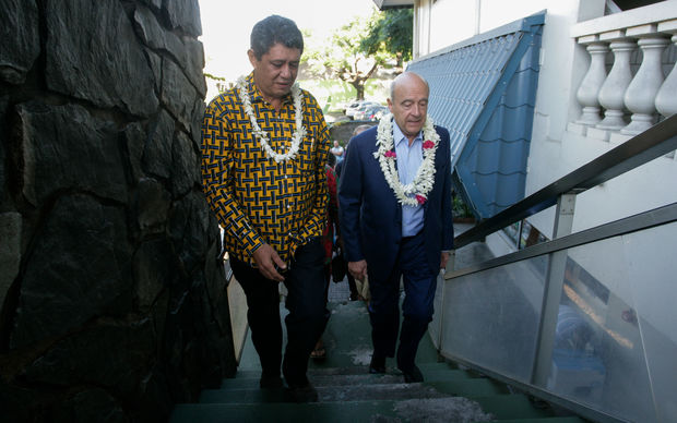 French candidate for President Alain Juppe  walks up stairs with Maohi protestant church's president Pastor Taaroanui Maraea in Papeete, French Polynesia, ahead of an anti-nuclear meeting.
