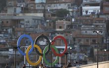 Olympic rings overlook a favela outside the Maracana stadium in Rio.