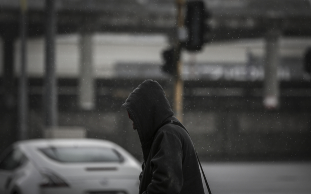 08092016 Photo: Rebekah Parsons-King. Wild weather. A main walks in the heavy rain.