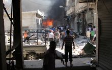 Syrian men search for victims at the scene of a reported air strike on the rebel-held northwestern city of Idlib.