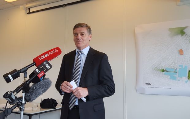The Minister Responsible for Housing New Zealand, Bill English, makes the announcement in front of plans for the new housing.