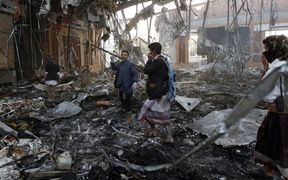 Yemeni rescue workers search for victims amid the rubble of a destroyed building following attacks blamed on Saudi-led coalition air strikes in the capital Sanaa.
