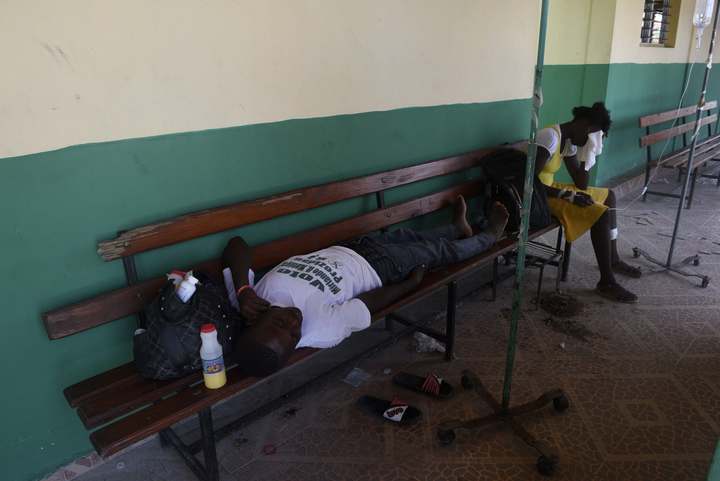 A man affected by cholera lies on a bench, following the passage of Hurricane Matthew, at the hospital in Port-Salut. Officials fear a cholera outbreak could add to the hurricane's death toll of 900.
