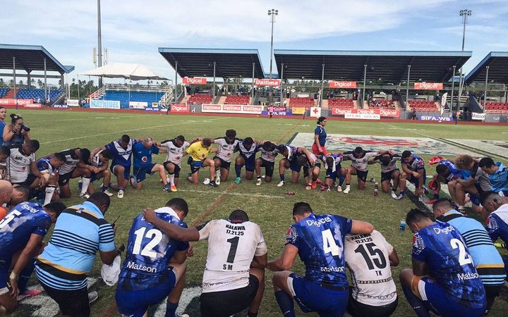 Toa Samoa and Fiji Bati players pray post match in Apia.