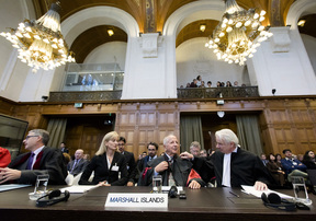 The Marshall Islands' delegation including lawyer Laurie B. Ashton (L), Luigi Condorelli (C) from the University of Florence and Phon van den Biesen (R), lawyer of the Marshall Islands' delegation) sit at the International Court of Justices (ICJ) in the Hague, on October 5, 2016.