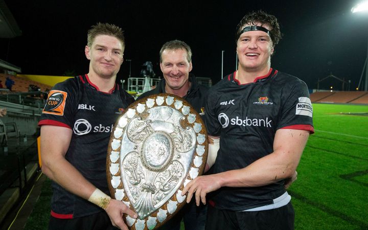 Canterbury's Jordie Barrett and Scott Barrett with their father Kevin holding the Ranfurly Shield.