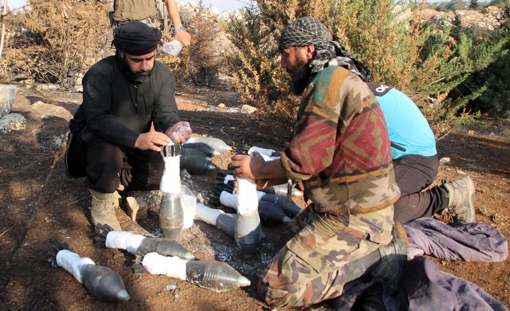 Rebel fighters from the Jaish al-Fatah (or Army of Conquest) brigades prepare mortar shells before firing towards western government-controlled districts on October 30, 2016 at an entrance to Aleppo.