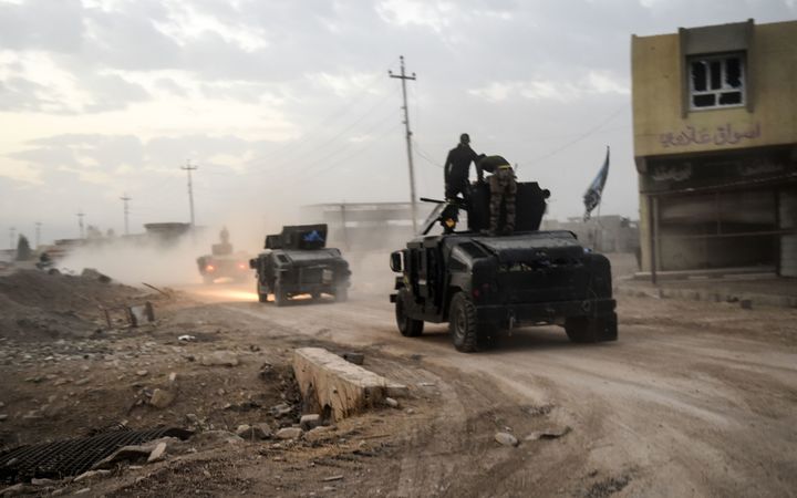 Members of the Iraqi Counter Terrorism Service (CTS) drive near the village of Bazwaya, on the eastern edges of Mosul, tightening the noose on Mosul as the offensive to retake the Islamic State group stronghold entered its third week on October 31, 2016. 
