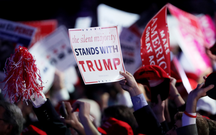 NEW YORK, NY - NOVEMBER 09: People hold up a sign in support of Republican presidential nominee Donald Trump during the election night event at the New York Hilton Midtown on November 8, 2016 in New York City. Spencer Platt/Getty Images/AFP