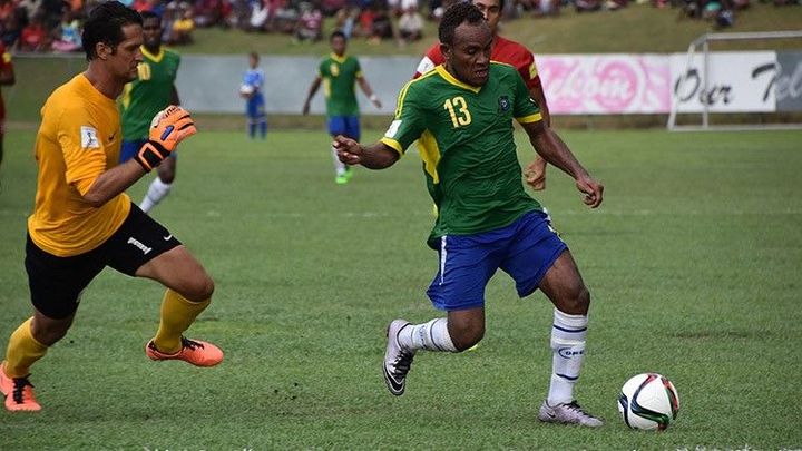 James Naka attempts to round Tahiti goalkeeper Michael Roche. 