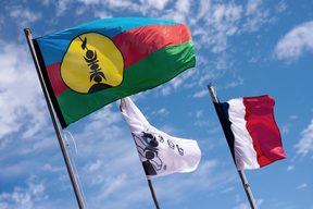 Kanak and French flags on Ouvea island. 