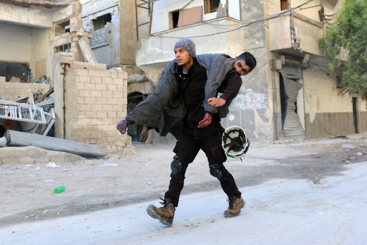 A Syrian civil defence volunteer, known as the White Helmets, carried an injured man following air strike on Aleppo's rebel-held neighbourhood of Bab al-Nayrab. 
