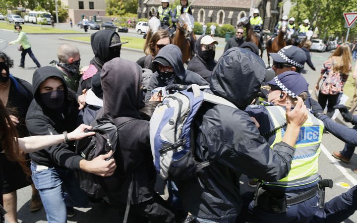 : Police attempt to restrain protesters during a confrontation between two rival groups, No Room for Racism and the far-right United Patriots Front, near State Parliament in Melbourne on November 28, 2015.