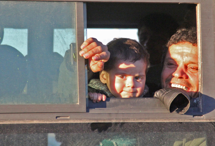 Syrians evacuated from rebel-held neighbourhoods in Aleppo arrive in the opposition-controlled Khan al-Aassal region, west of the city, on 15 December. Civilians will be taken to temporary camps on the outskirts of Idlib and the wounded to field hospitals.