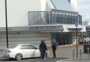 Police conduct interviews outside the Napier courthouse.