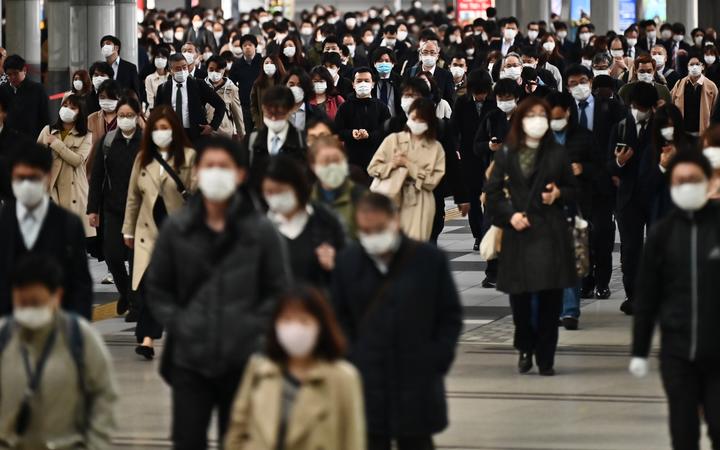 People commute to work despite a state of emergency in Japan at Shinagawa station in Tokyo on April 16, 2020.