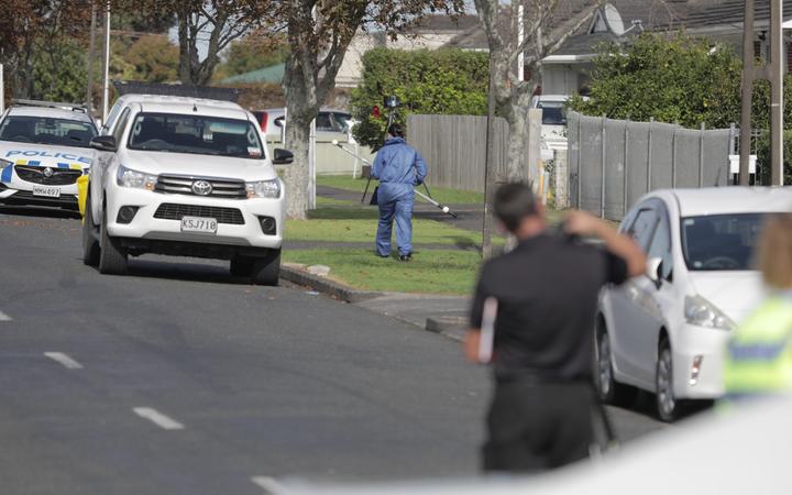 Police at Central Avenue in Papatoetoe after a man wielding a machete was shot dead.