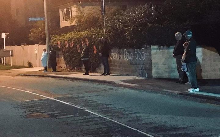 People on Hillsborough Road in Auckland this on Anzac Day.