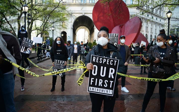 A large group of protesters, marched on New York's Police Headquarters decrying police brutality against African-Americans following the killing of Ahmaud Arbery, 11 May 2020, in New York.