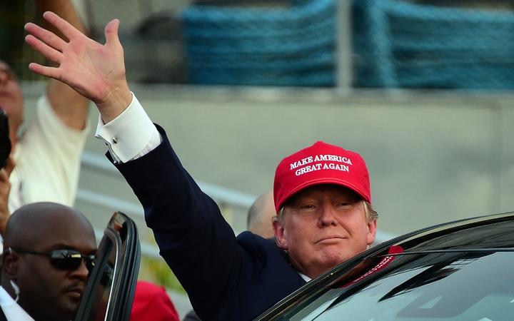 Republican Presidential candidate Donald Trump waves as leaves following a speech on board the Worl War II bettlaship USS Iowa in San Pedro, California on September 15, 2015. 