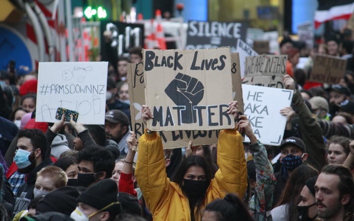 A protester holds a placard at the George Floyd / Black Lives Matter Auckland march on 1 June 2020.