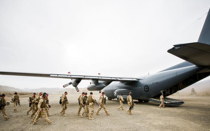 NZ Defence Force personnel boarding a Hercules plane.