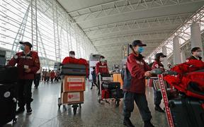 (200321) -- GUANGZHOU, March 21, 2020 (Xinhua) -- Members of Chinese anti-epidemic expert team to Serbia walk to the boarding gate at Guangzhou Baiyun International Airport in Guangzhou, capital of south China's Guangdong Province, March 21, 2020. 