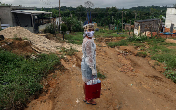 Witoto indigenous nursing assistant Vanda Ortega, 32, starting her round of healthcare visits in the Parque das Tribos, an indigenous community in the suburbs of Manaus, Amazonas State, Brazil, on May 3, 2020 during the Coivd-19 coronavirus pandemic. 