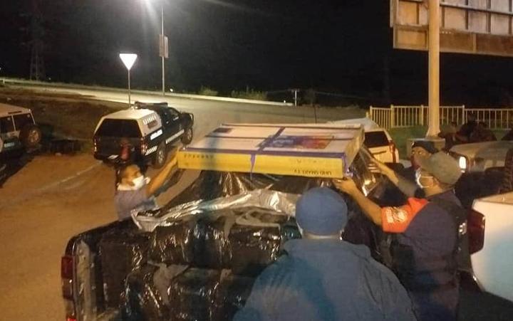 PNG police loading cartons of seized cocaine.
