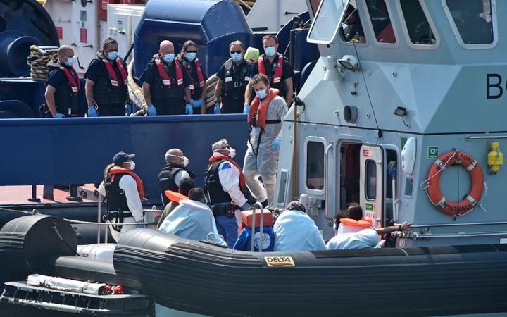UK Border Force officers come to meet migrants, believed to have been picked up from boats in the Channel, from Coastal patrol vessel "HMC Speedwell", in the port of Dove.
