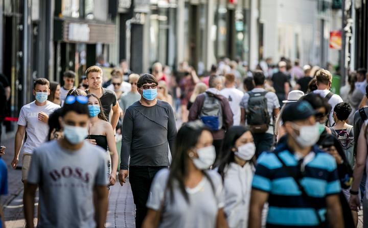 People, wearing a face mask, walk in the Kalverstraat, in Amsterdam, the Netherlands on August 5, 2020.