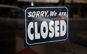 Sign that reads 'Sorry, We are closed' hanging in a shop front in Central Auckland during Lockdown Level 3.