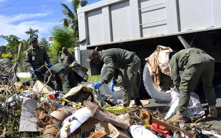 Soldiers clear rubbish during the LTDD campaign.