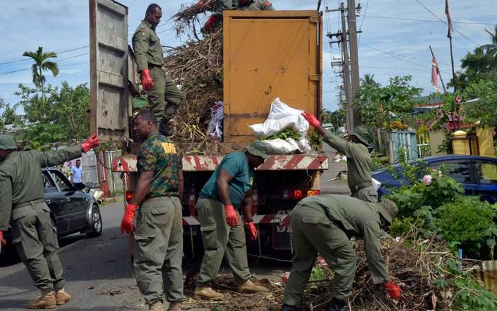 Soldiers help clean up in the capital Suva.